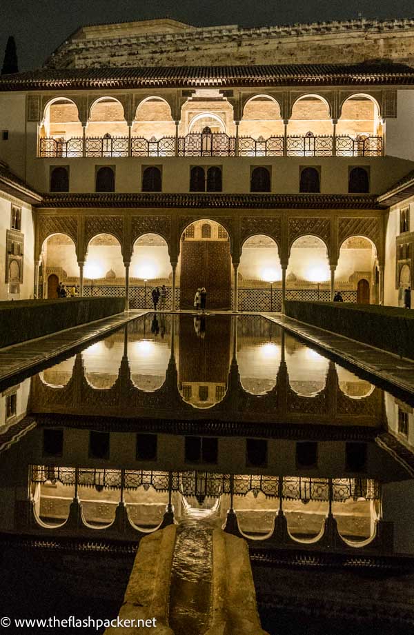 illuiminated carved dual layer colonnades and reflecting pool at night