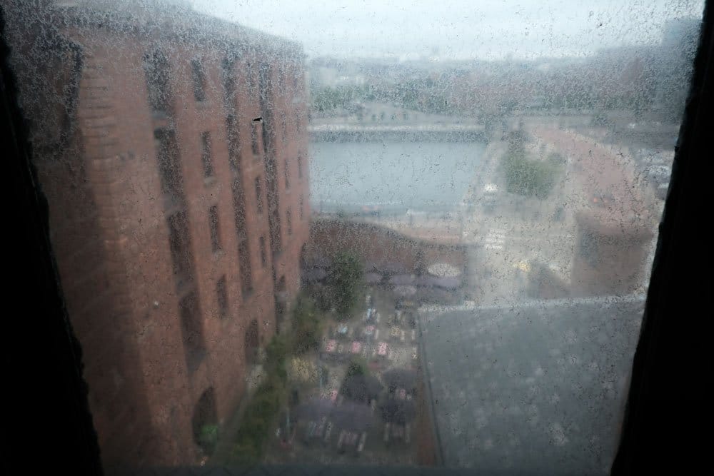 view of city and dock through a grimy window