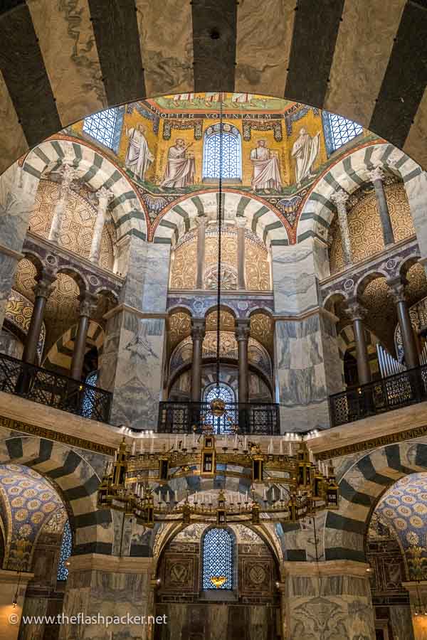 large candelabra hanging from the dome of aachener dom