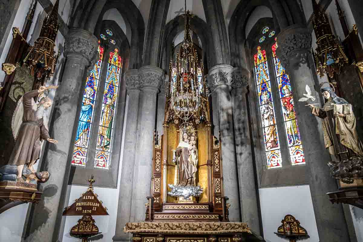 chapel in church with stained glass windows and statues