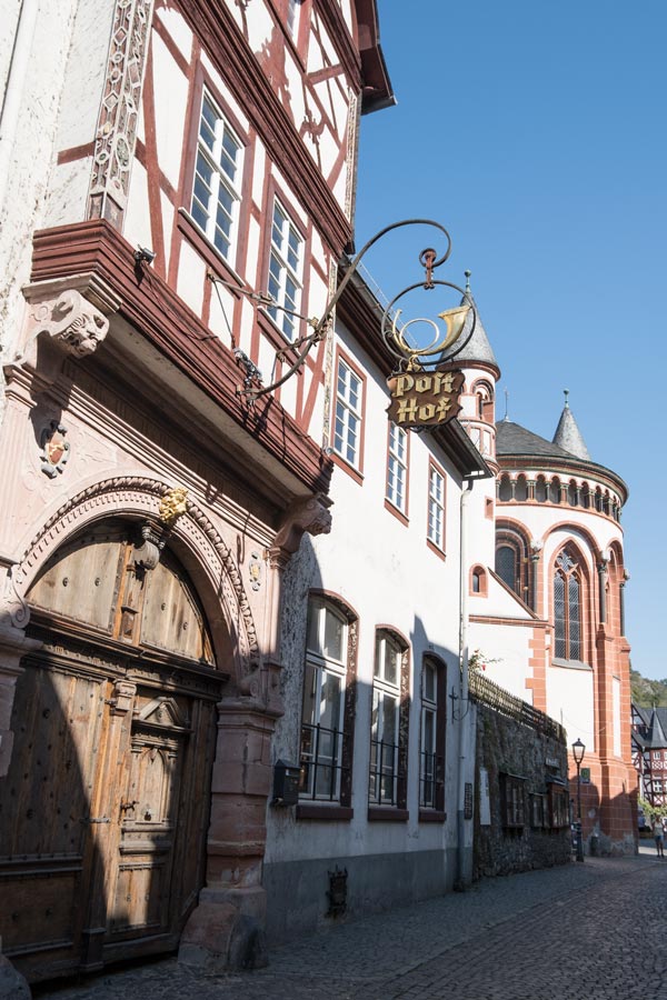 old half-timbered building with a metal sign saying Post Hof