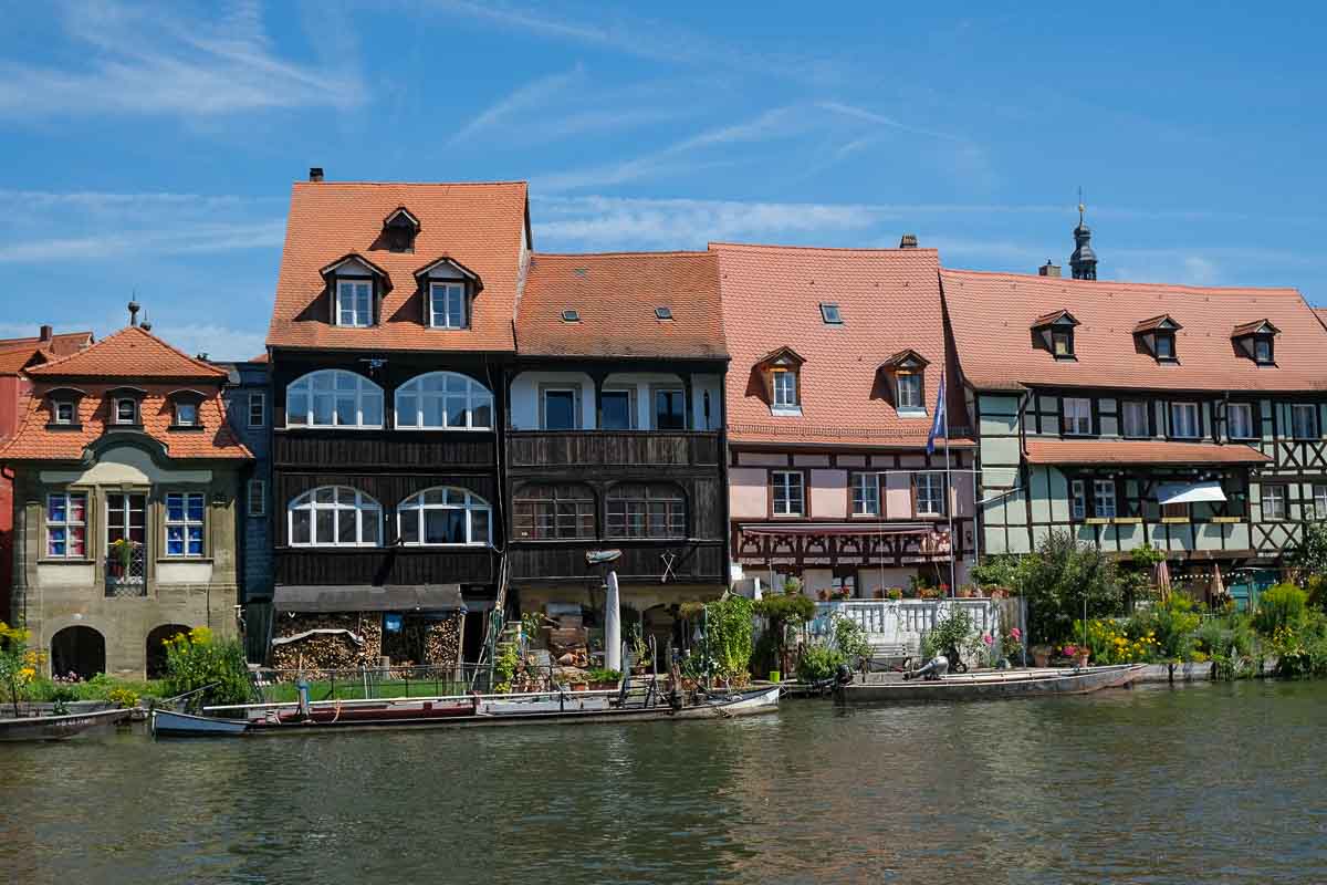 row of half timbered medieval houses by side of river