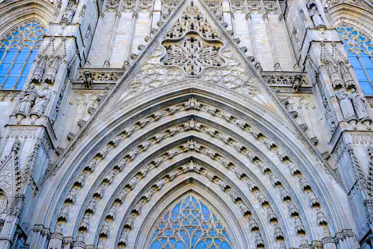 ornate gothic entrance to barcelona cathedral with intricate stone carvings