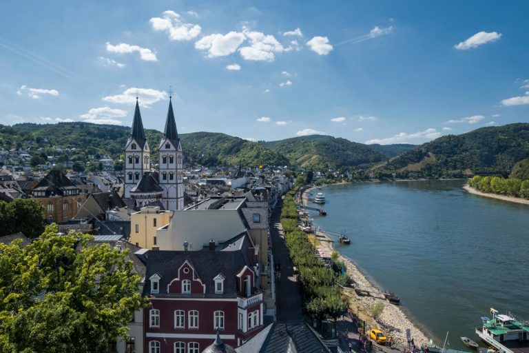 aerial view of medieval town of boppard germany with old buildings and 2 church spires next to a river