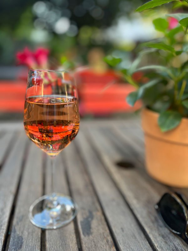 glass of rose wine on a wooden table