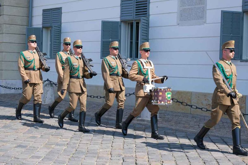 group of marching soldiers in uniform wearing sunglasses