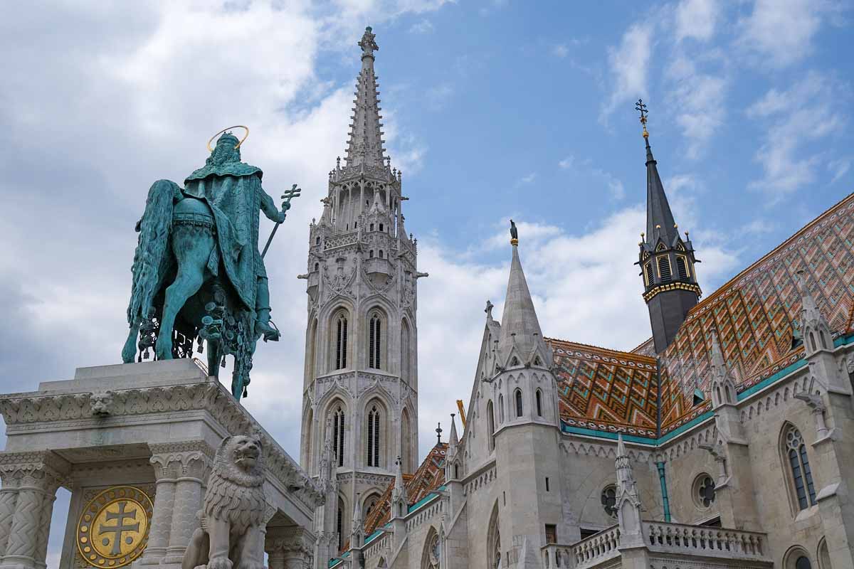 statues of st stephen on a horse in front of the matthias church in budapest