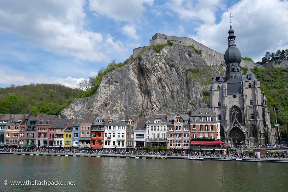 riverside lined with brightly coloured buildings and church with onion dome