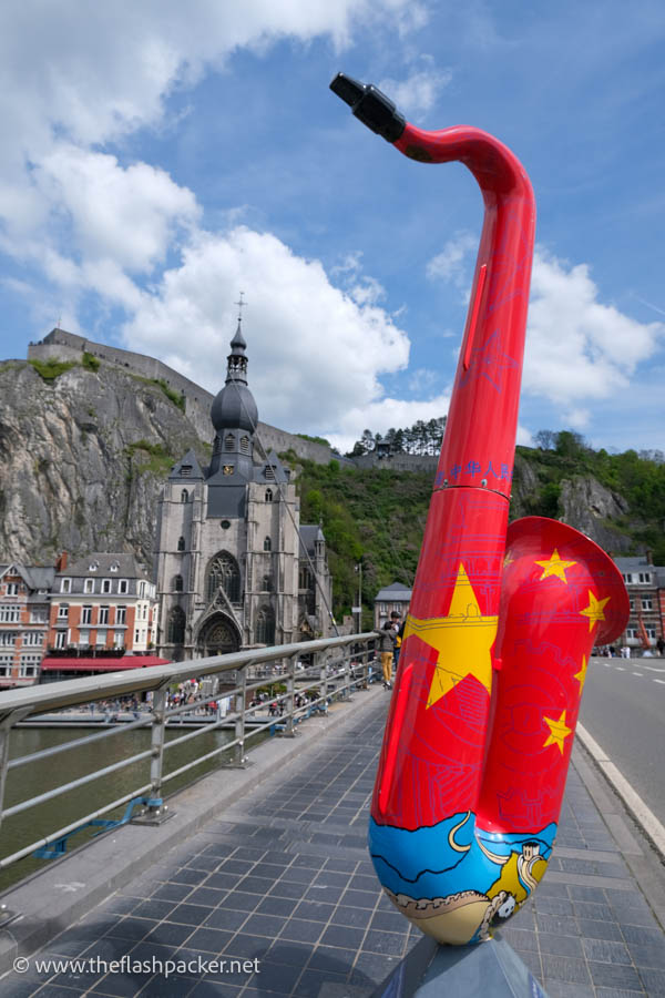 giant sculpture of a painted saxophone on a bridge in dinant belgium