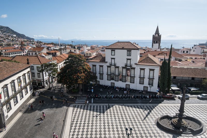 aerial view of the main square in funchal madeira with mosiac paving and ocean in background