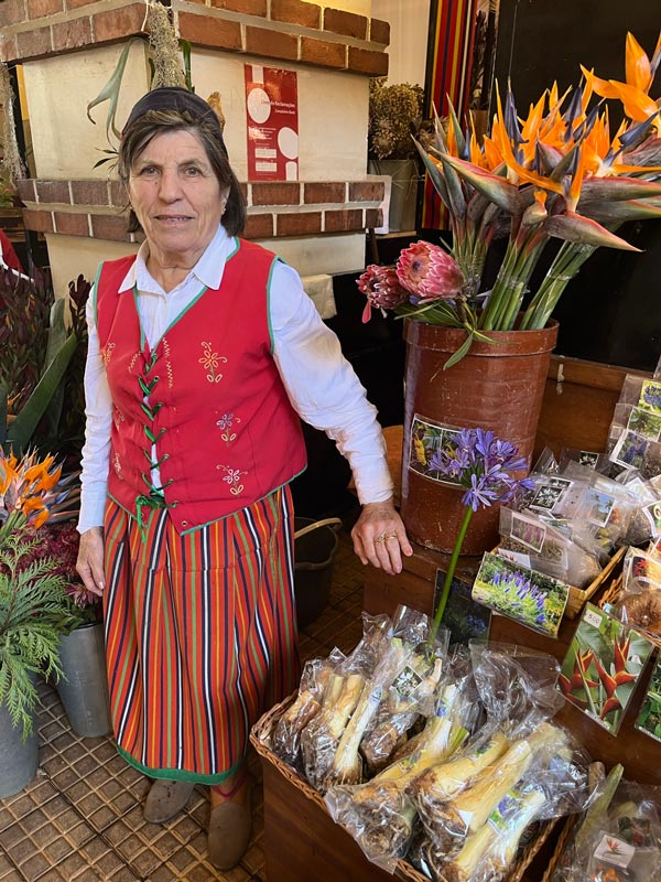 woman selling flowers in traditional dress of madeira