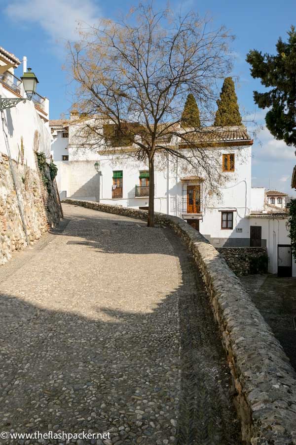 path winding alongside pretty whitewashed buildings