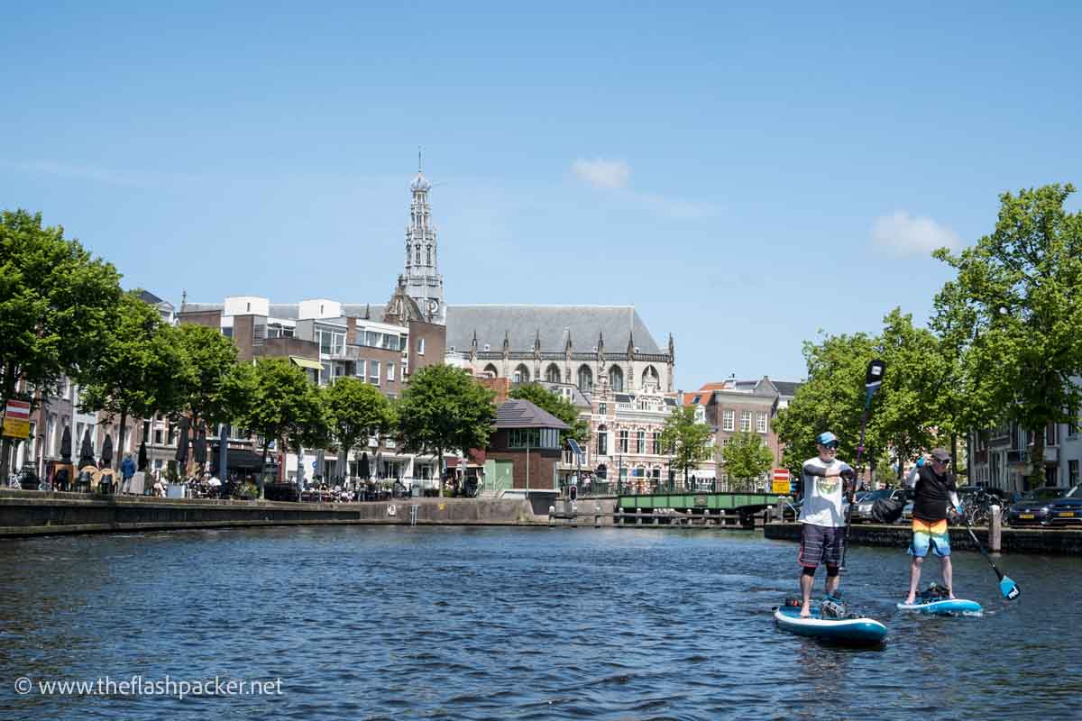 2 paddleboarders on a large canal in haarlem