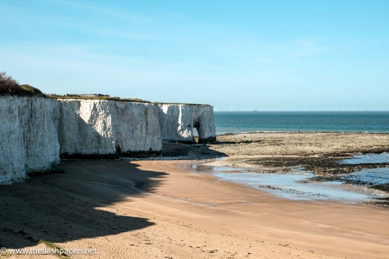 sandy-beach-against-a-cliff-face-with-limestone-arch-in-kent