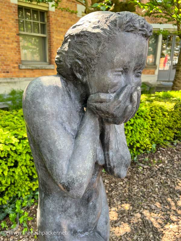 stone sculpture of a child laughing