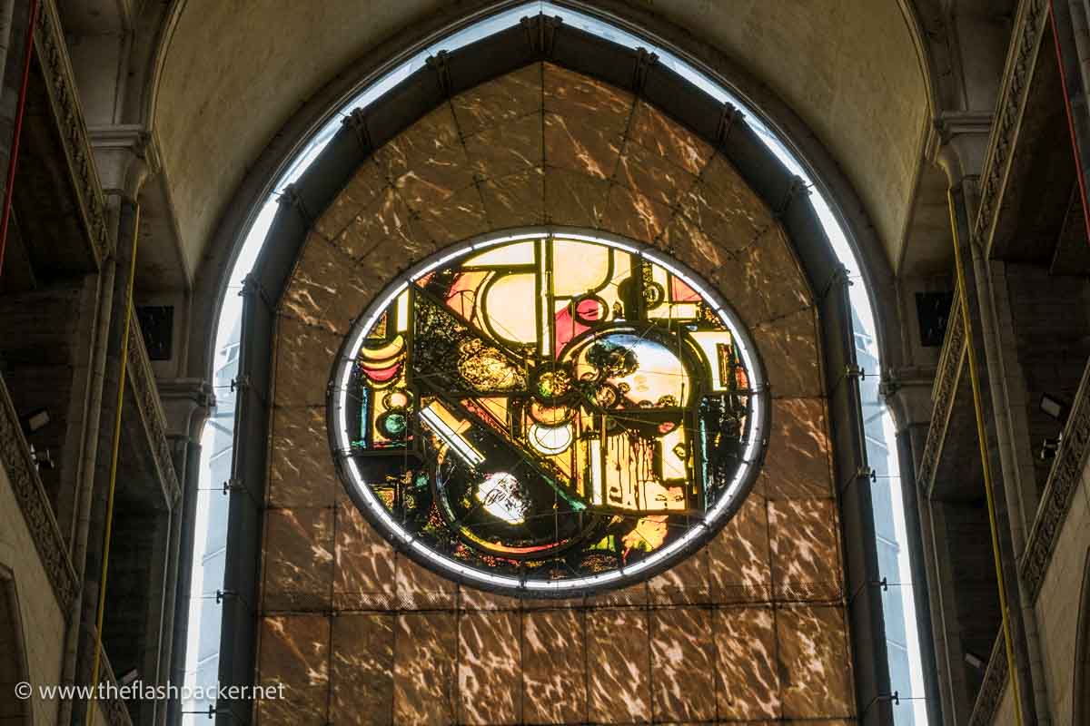 modern circular stained glass window filled with abstract symbols