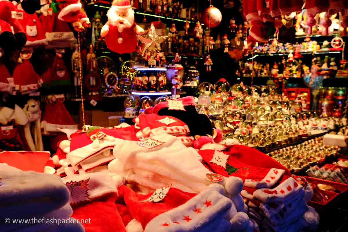 stall in a xmas market with decorations and santa hats