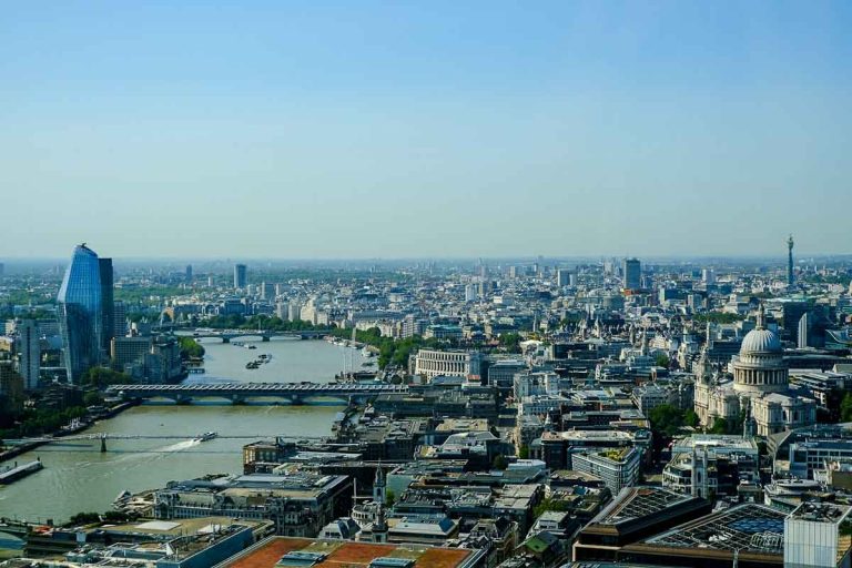 river thames with bridges and boats and london eye in distance