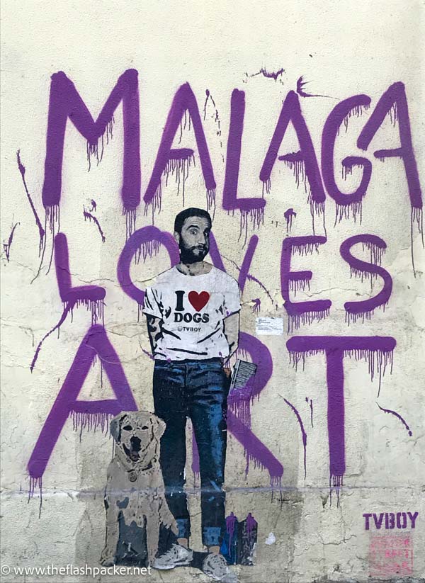 wall painted with malaga loves street art and man with dog