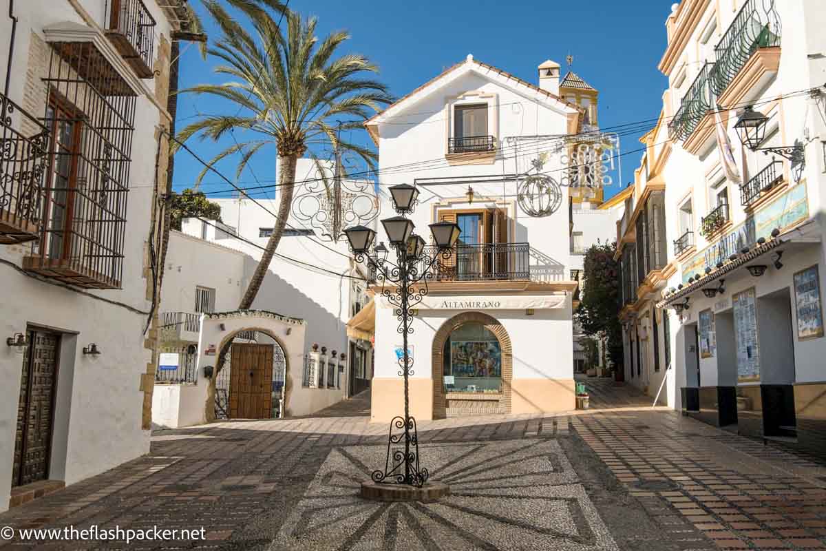 pretty pizza in marbella old town with central lampost with 5 lamps