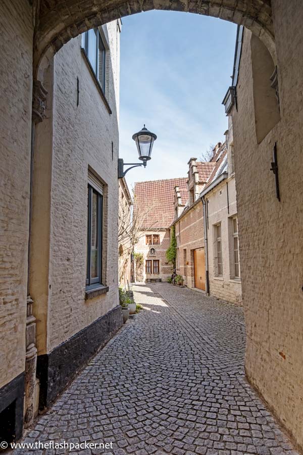 narrow cobblestone lane and arch in mechelen belgium