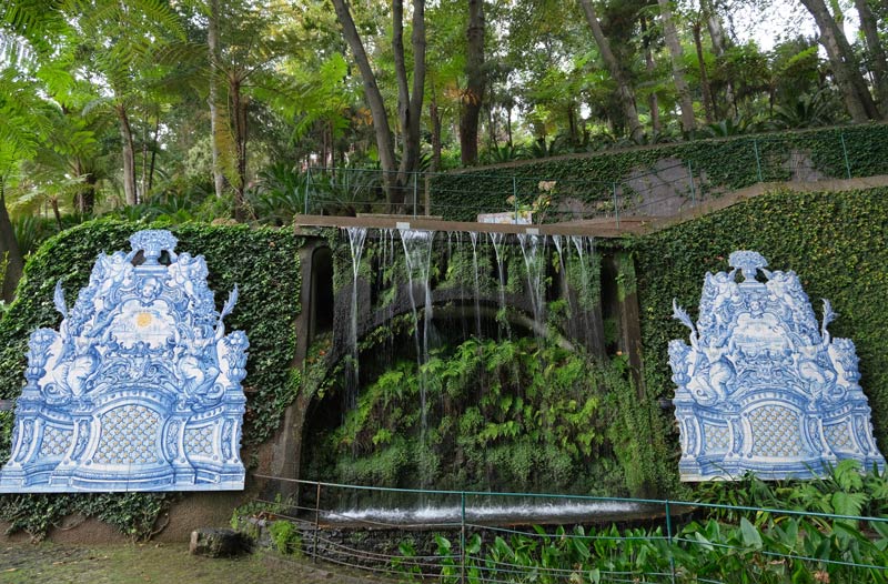 a waterfall between two giant plaques made from blue and white tiles