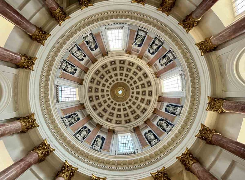 interior church dome supported by pink marble columns