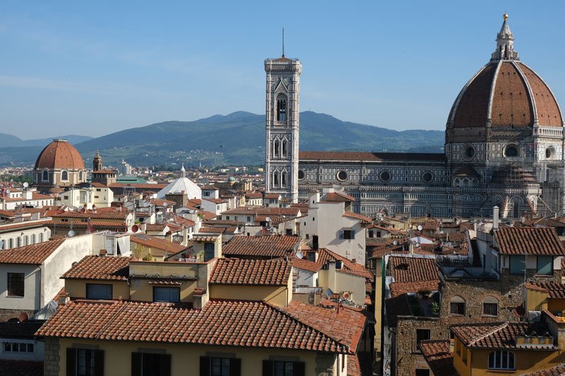 view of florence rooftops and dome and bell tower of cathedral from arnolfo tower