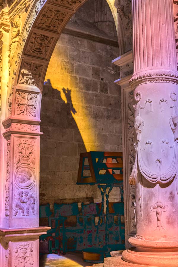 coloured light illuminating carved stone pillars