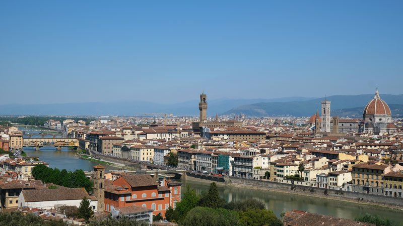 the river arno with bridges and the skyline of the city of florence in italy