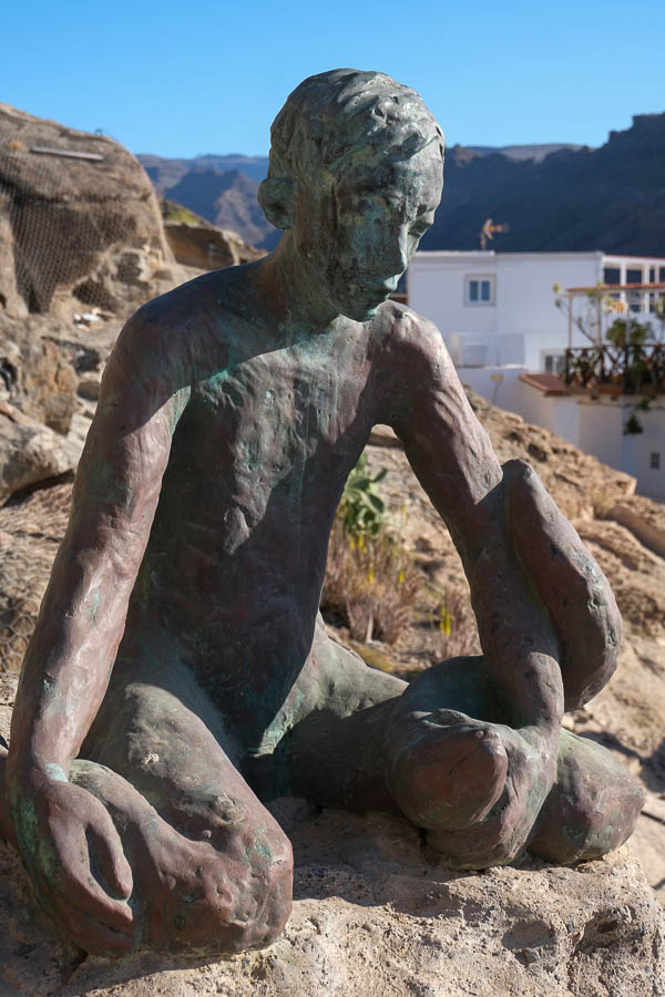 bronze modern sculpture of a sitting man