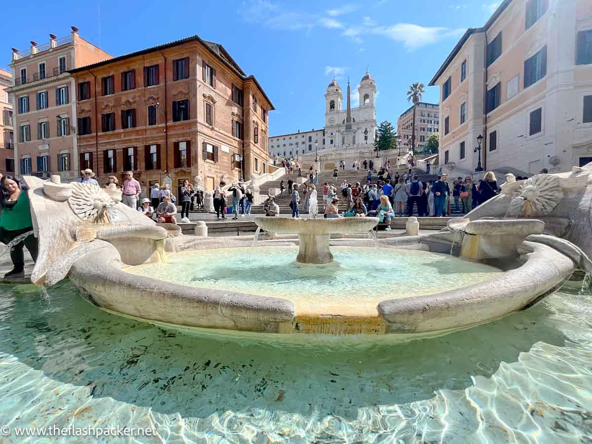 low fountain with water in piazza front of the Spanish steps in rome italy