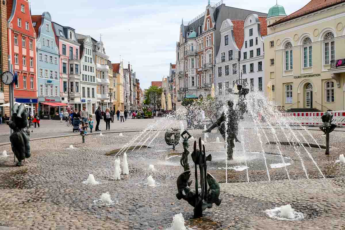 fountain and gabled buildings in cobblestone plaze in Rostock