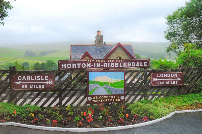 horton in ribblesdale railway station sign with station house