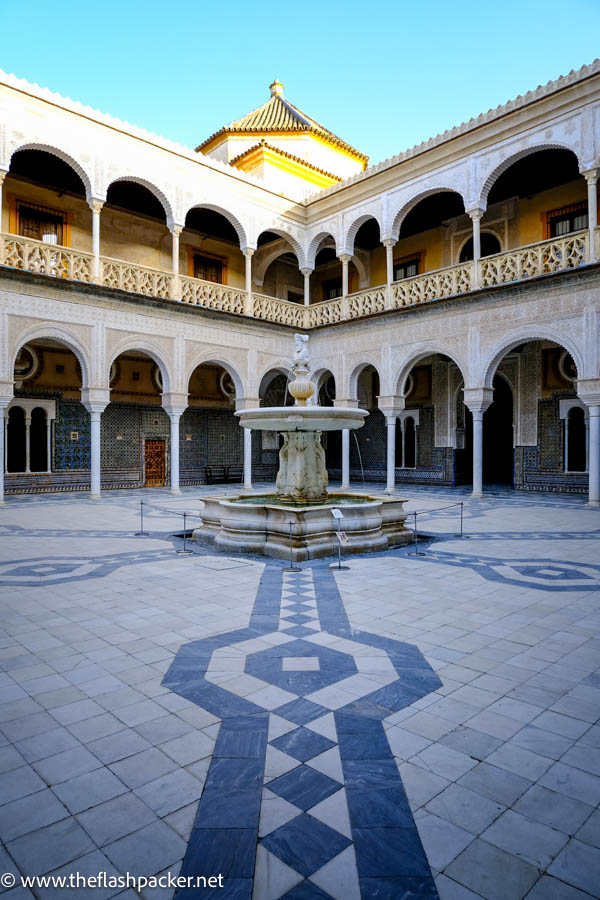 courtyard with central fountain surrounded by dual layer collonade