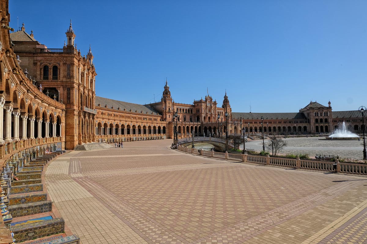 immense plaza with curved collonaded loggia and tiled plaques seen on a triop from málaga to seville