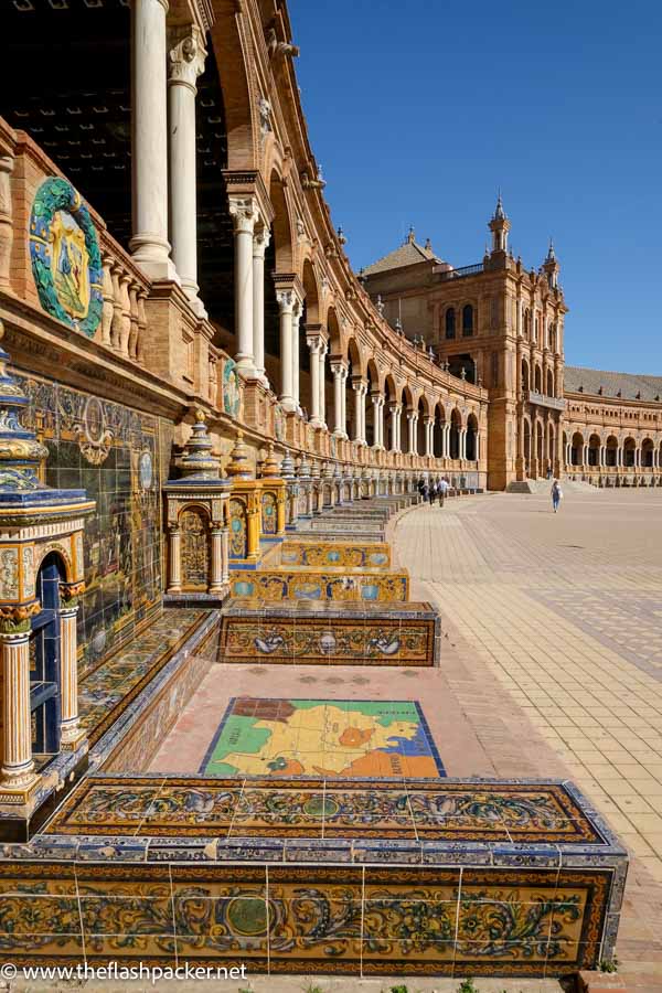 facade of semi-cricular grand colonnaded building at plaza de espana in seville spain