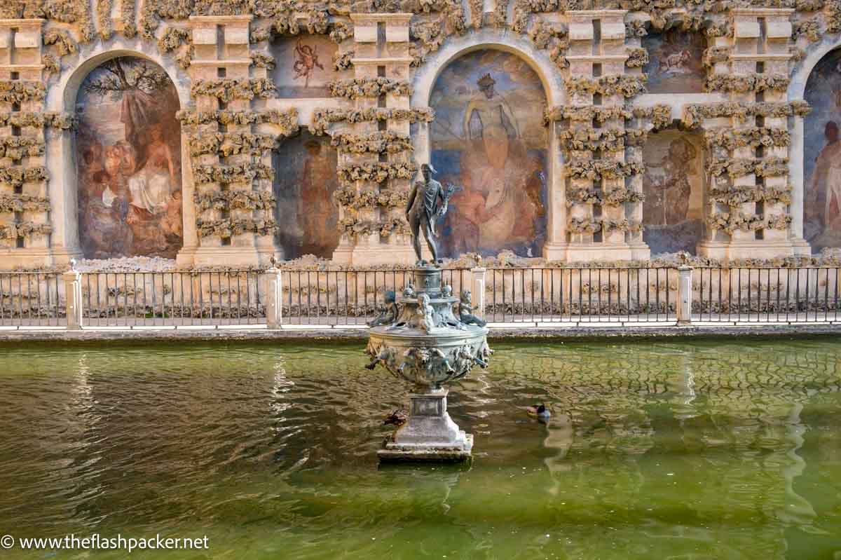 small statue in middle of pond