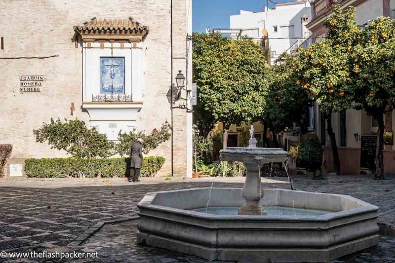 pretty piazza with fountain and woman