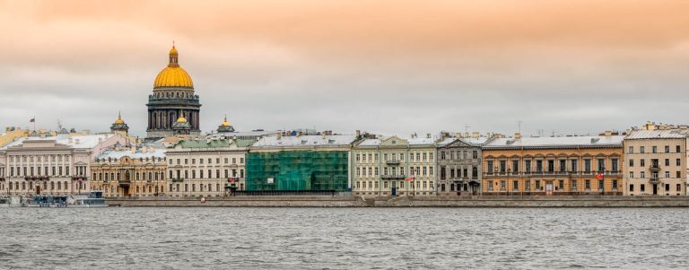 buildings along riverfront in st petersburg at sunset