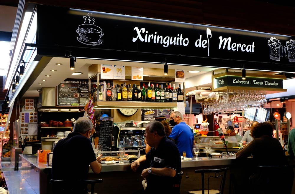 bar in market with people chatting and eating