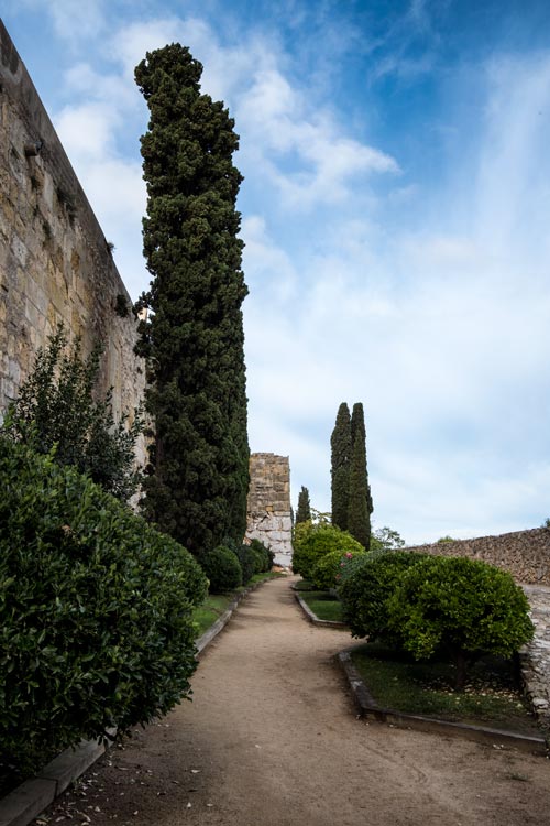 promenade with high stone walls and trees