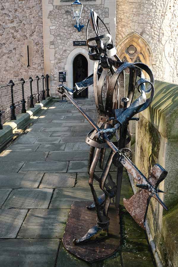 iron sculpture of a guard on a battlement at tower of london