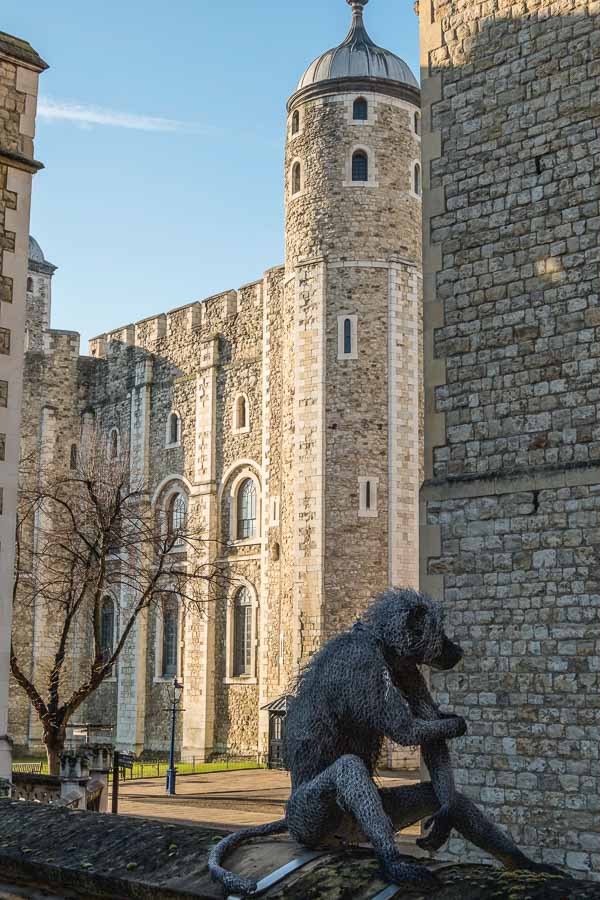 model of monkey in front of grand turreted building of tower of london