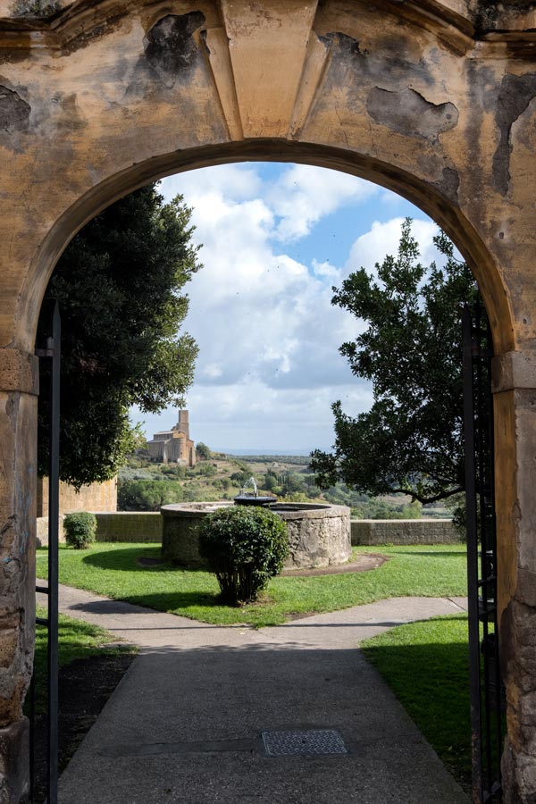 old arched gateway leading into a small park