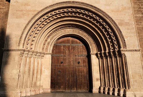 door of cathedral with carved romanesque arch