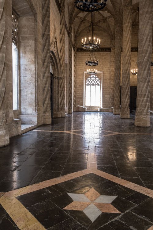 gothic large room lined with a row of twisted pillars