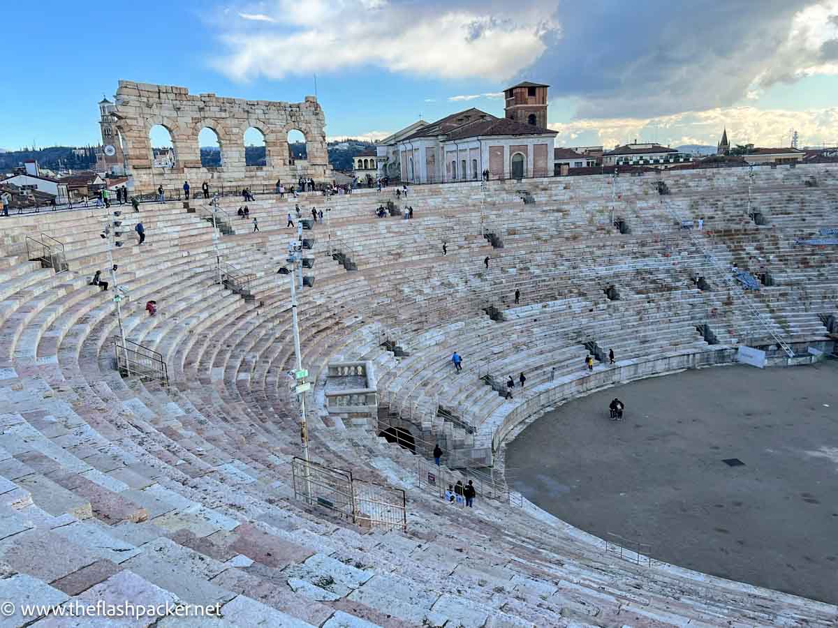 interior of massive roman arena in verona with ranked steps and arches at top