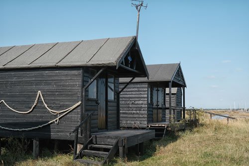 dark wood fishermens huts on walberswick beach