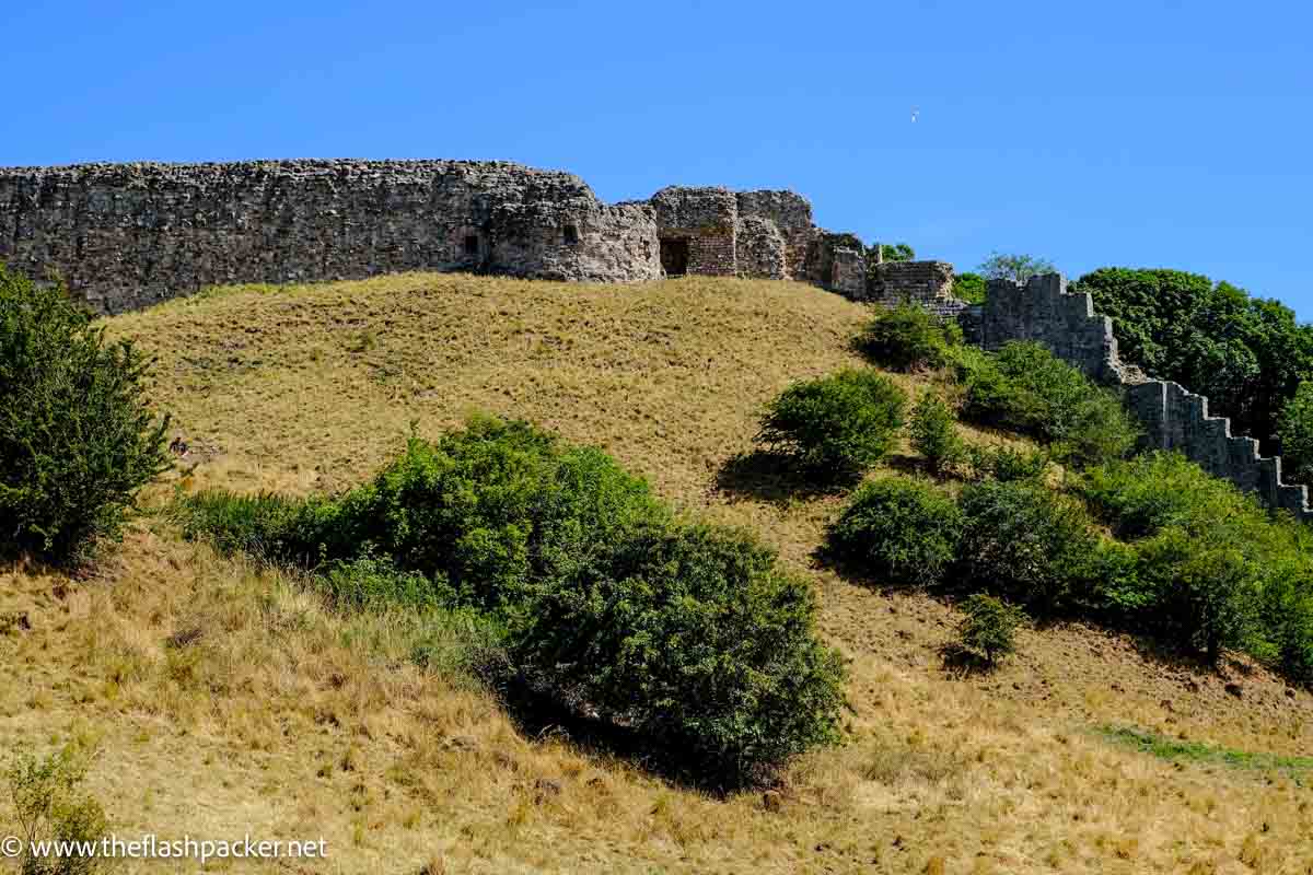 ruins of castle on grassy mound 